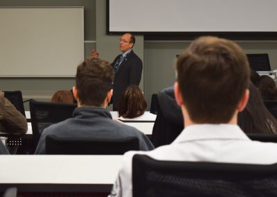 photo of Dean speaking to group of students